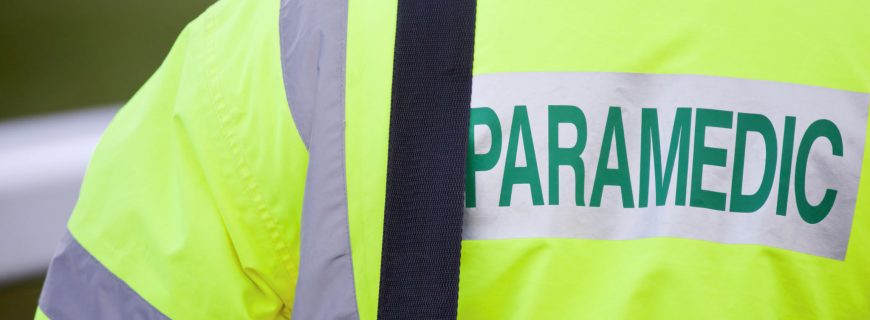 An emergency Paramedic in attendance at a UK outdoor event wearing a fluorescent high visibility jacket.